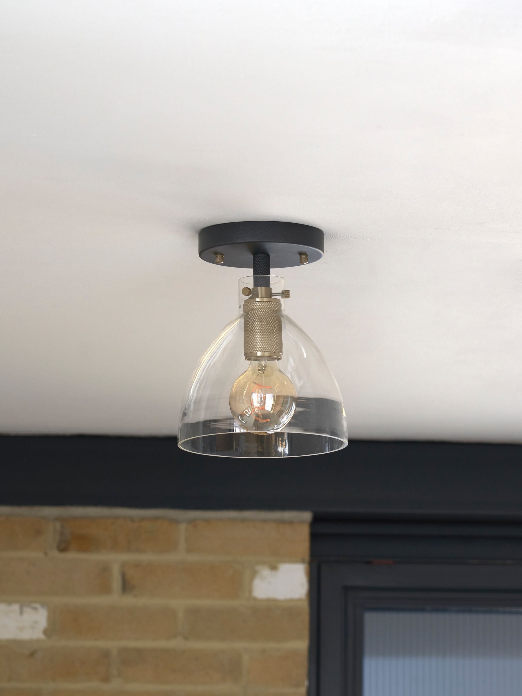 Black flush fitting ceiling light with brushed brass accents, 25.5cm height - British product