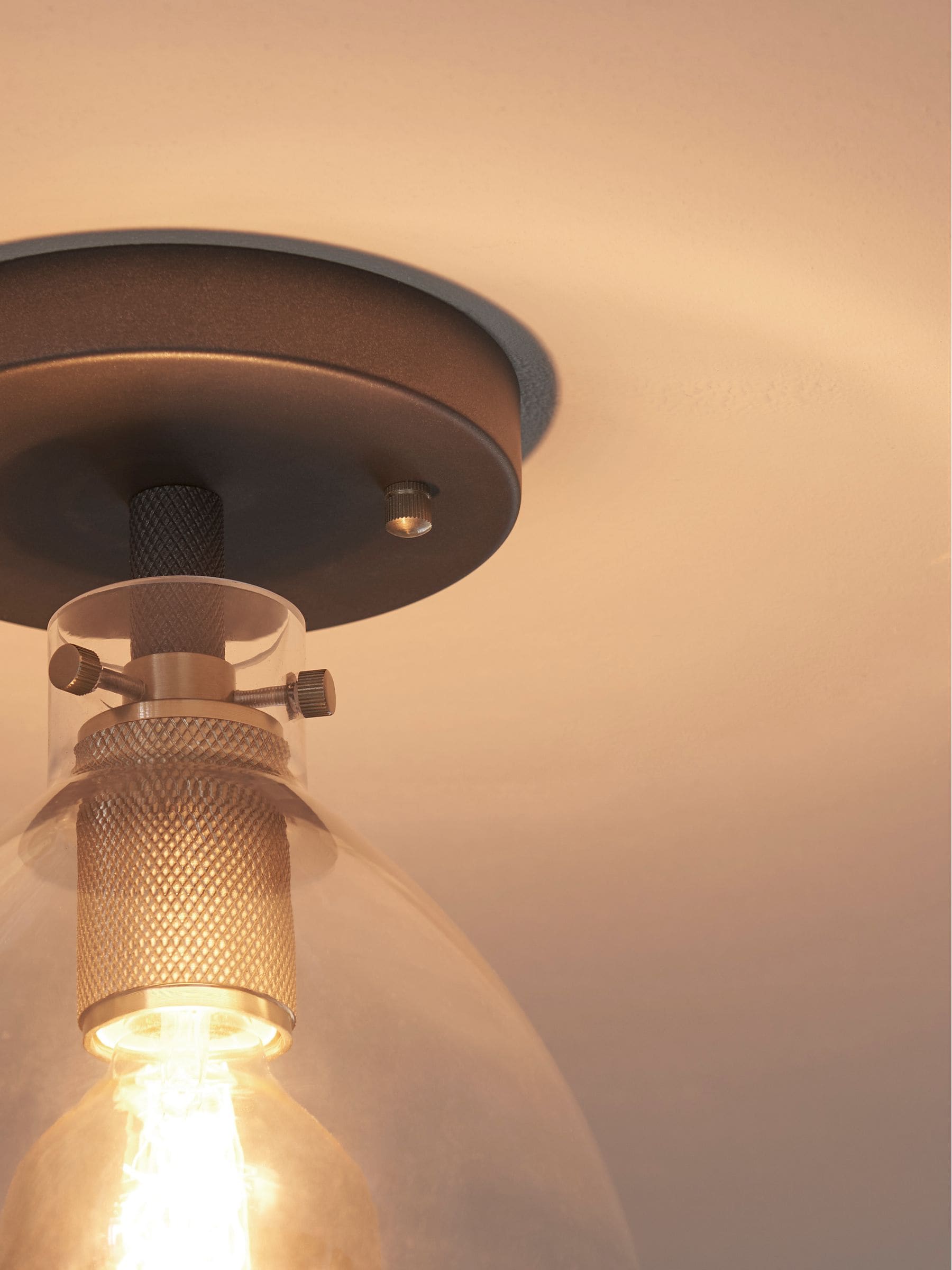 Black flush fitting ceiling light with brushed brass accents, 25.5cm height - British product