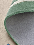 Joules sage green wool rug with scalloped border, imported from the UK