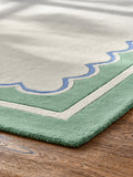 Joules sage green wool rug with scalloped border, imported from the UK