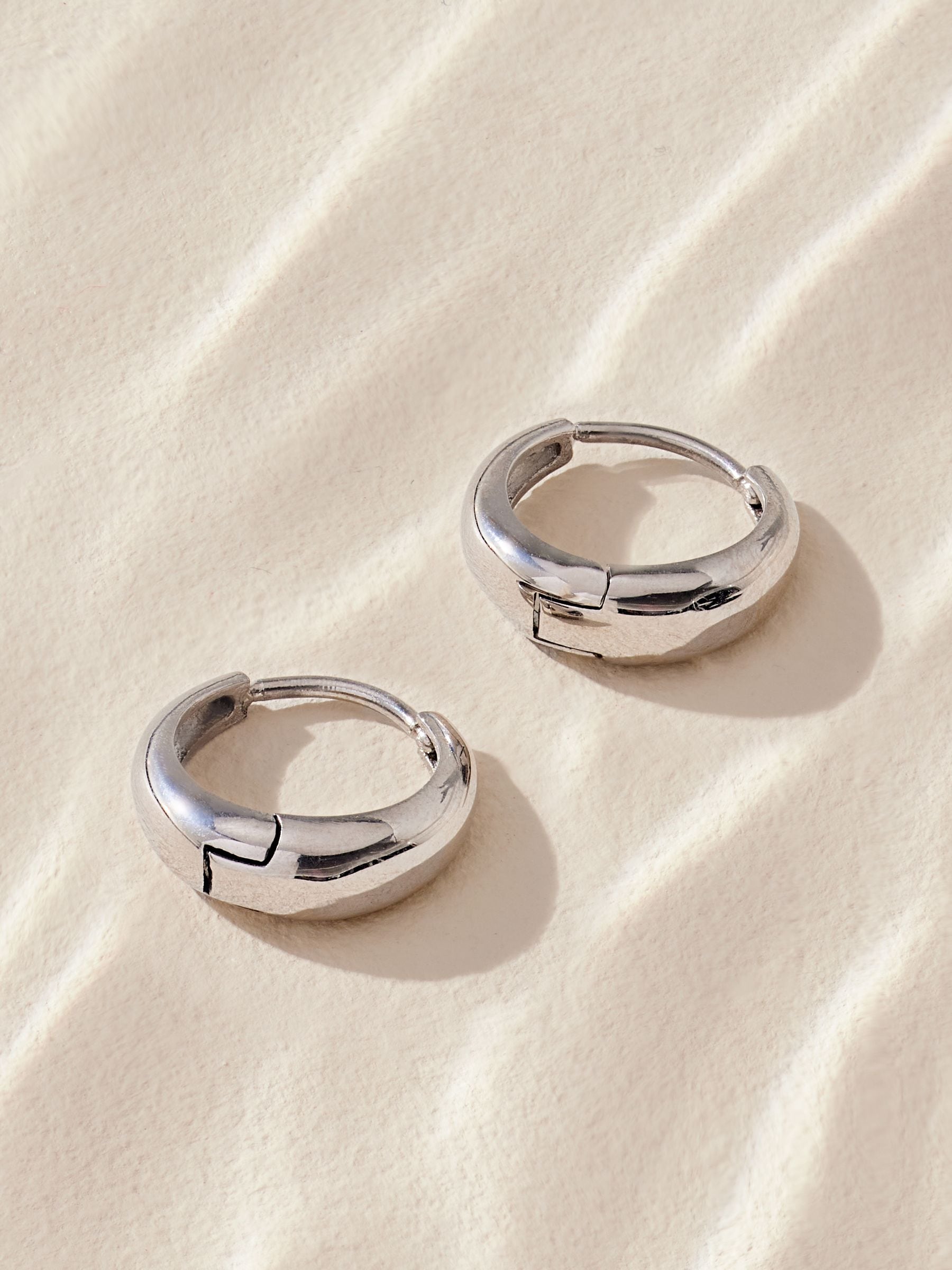 Silver tone stainless steel huggie hoop earrings (British brand)