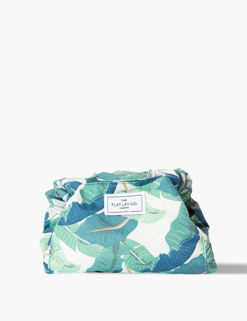 The Flat Lay Co. makeup bag Tropical Leaves design 52cm diameter, imported from the UK