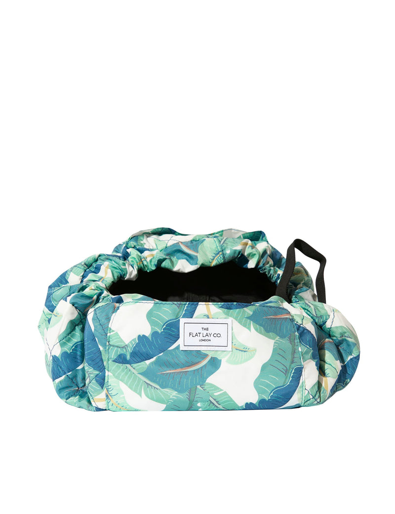 The Flat Lay Co. makeup bag Tropical Leaves design 52cm diameter, imported from the UK