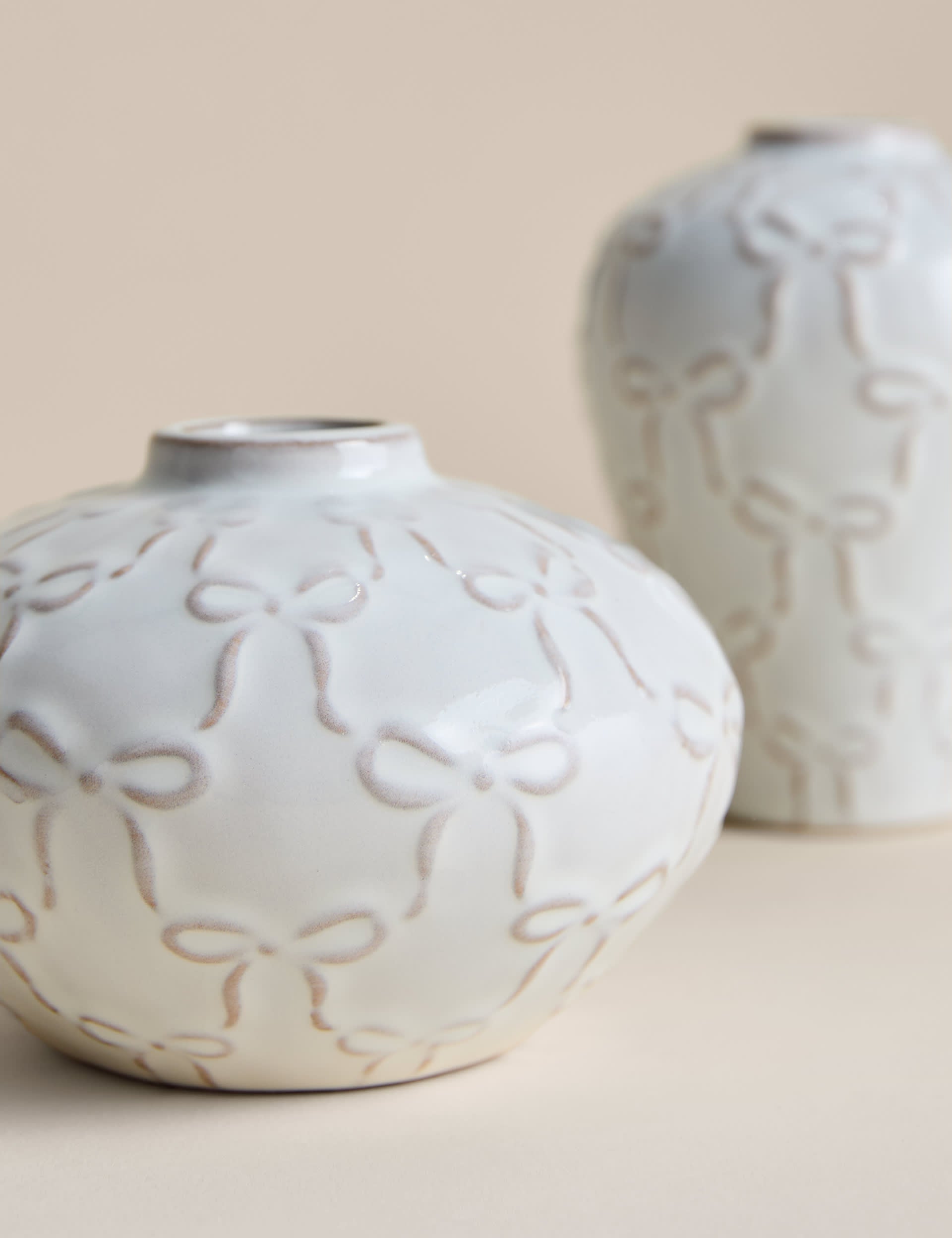 Set of two mini ceramic bow vases, imported from the UK