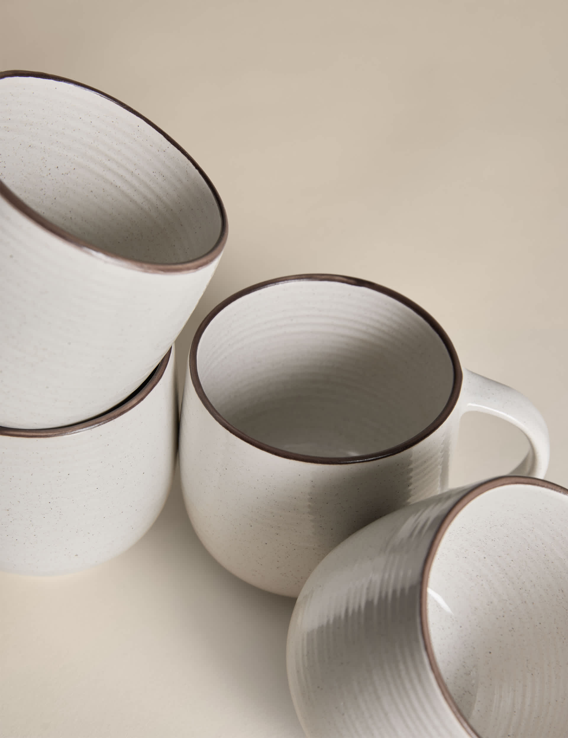 Set of four speckled ceramic mugs with contrast rims - British product