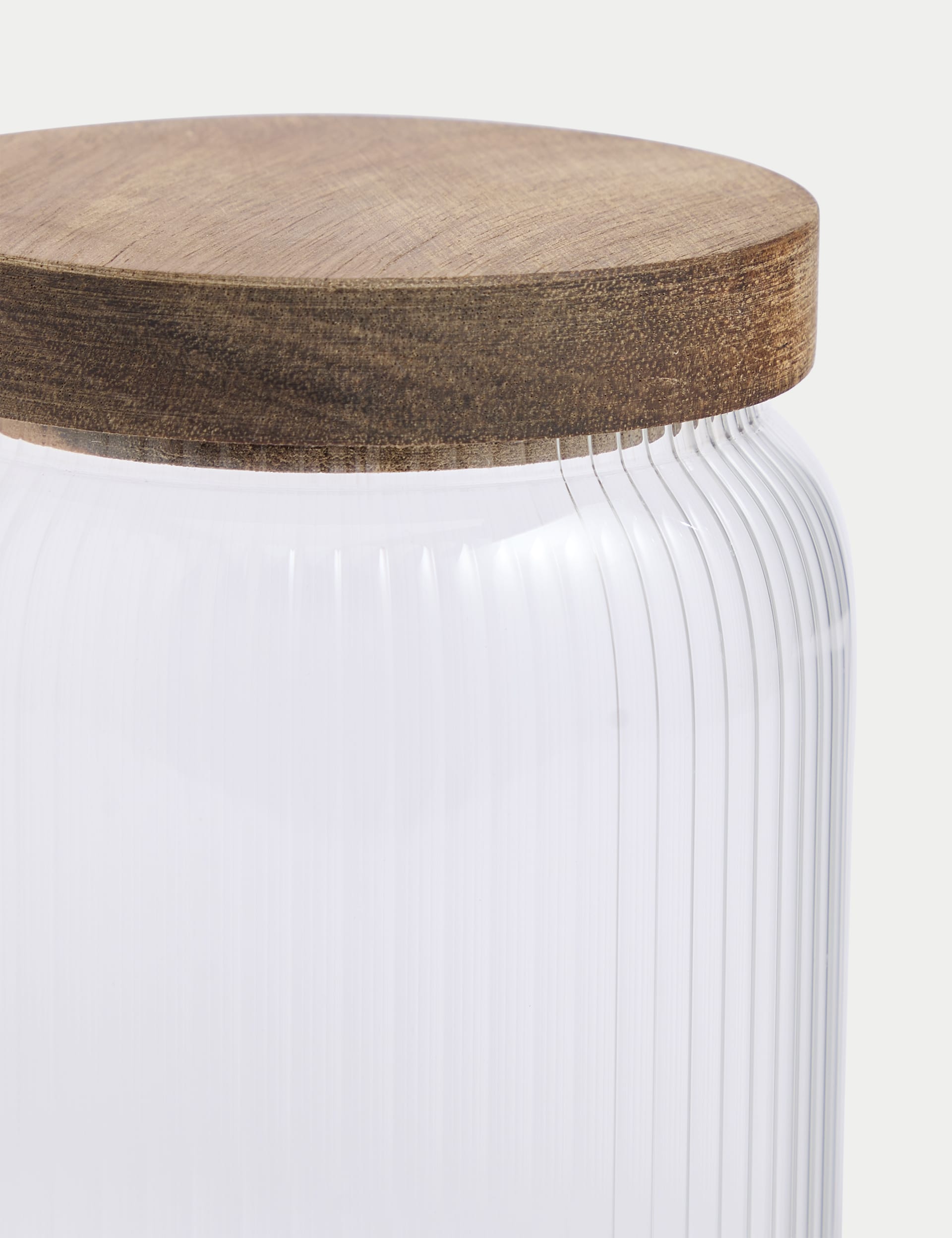 Medium ribbed glass storage jar with wooden lid, 16cm tall, imported from the UK
