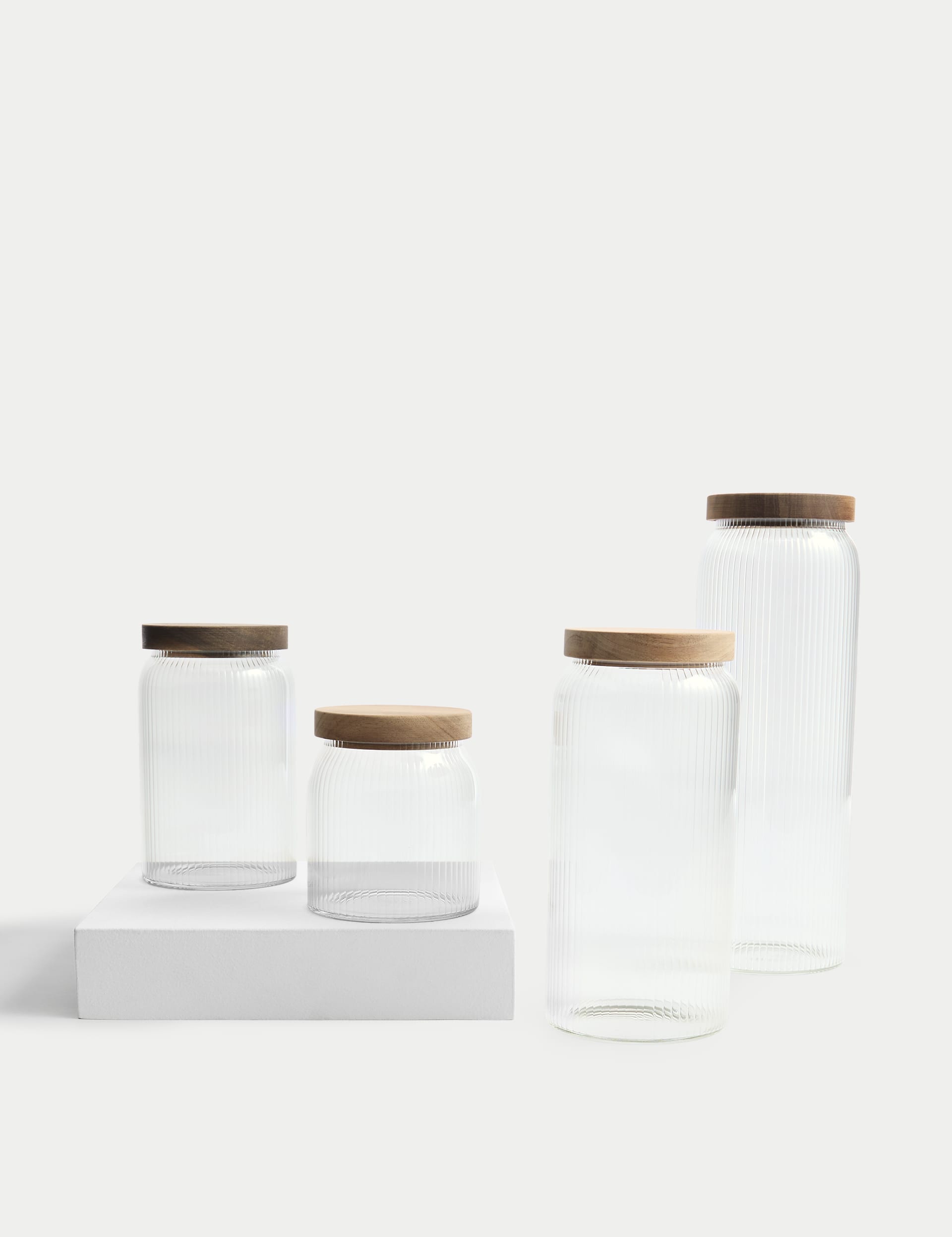 Medium ribbed glass storage jar with wooden lid, 16cm tall, imported from the UK