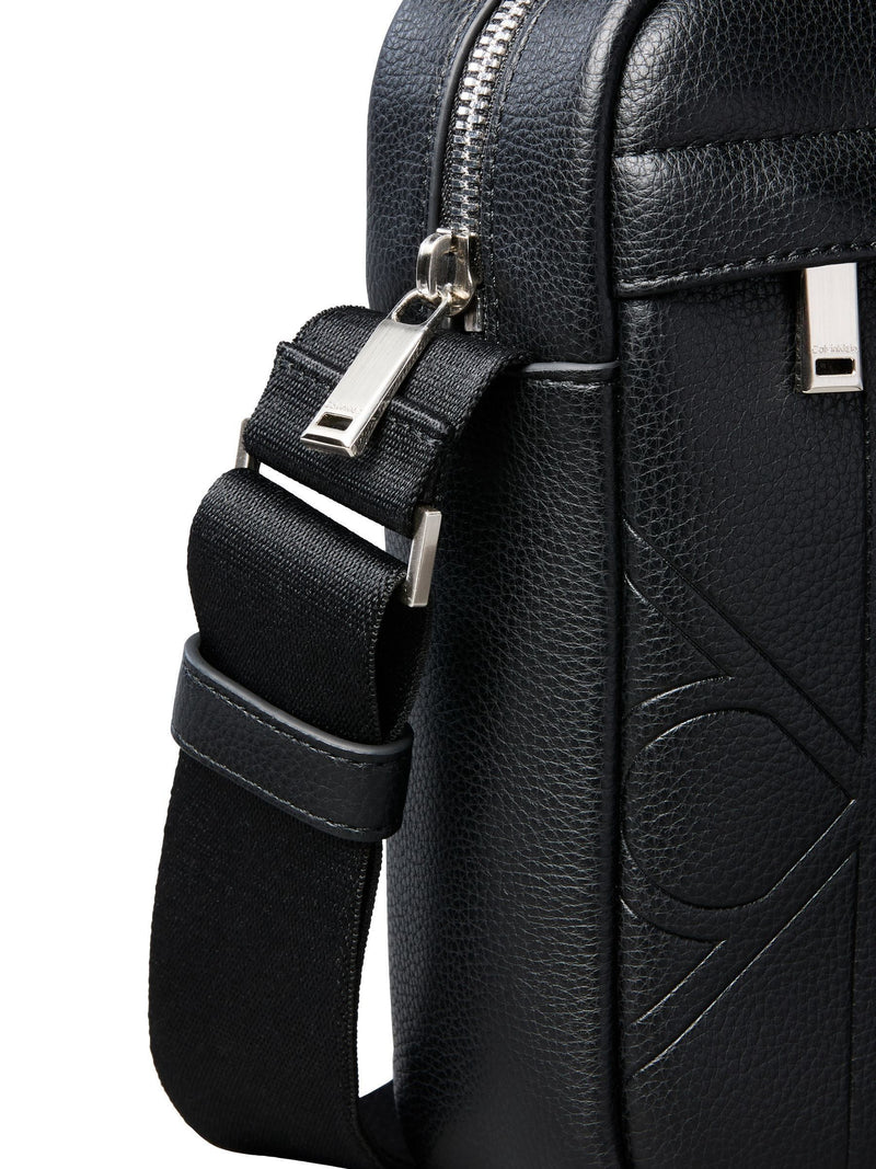 Calvin Klein black embossed emblem reporter bag, UK version
