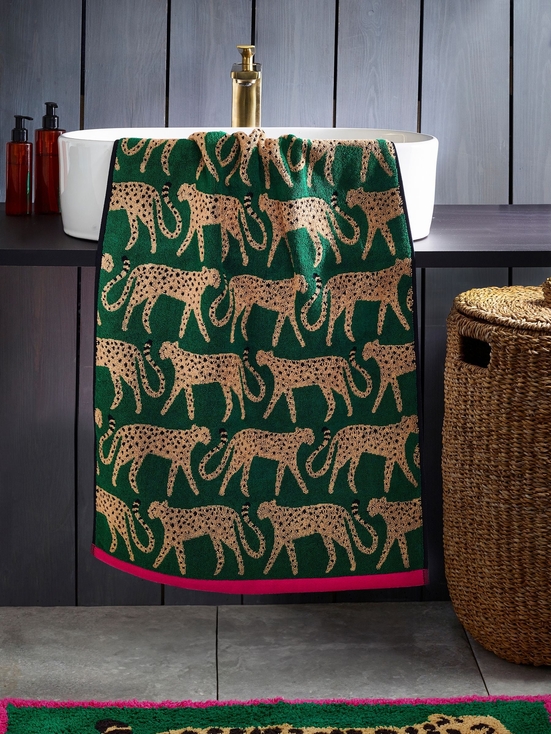 100% cotton cheetah towel in green with pink trim, imported from the UK