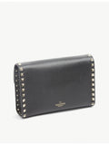 Valentino Garavani Rockstud leather crossbody satchel with gold-tone hardware (British brand)