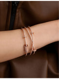 APM Monaco triple-band cuff bracelet rose gold plated cubic zirconia, UK version