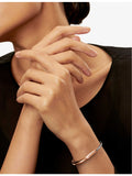 Tiffany & Co. Lock 18ct two-tone bangle bracelet, imported from the UK