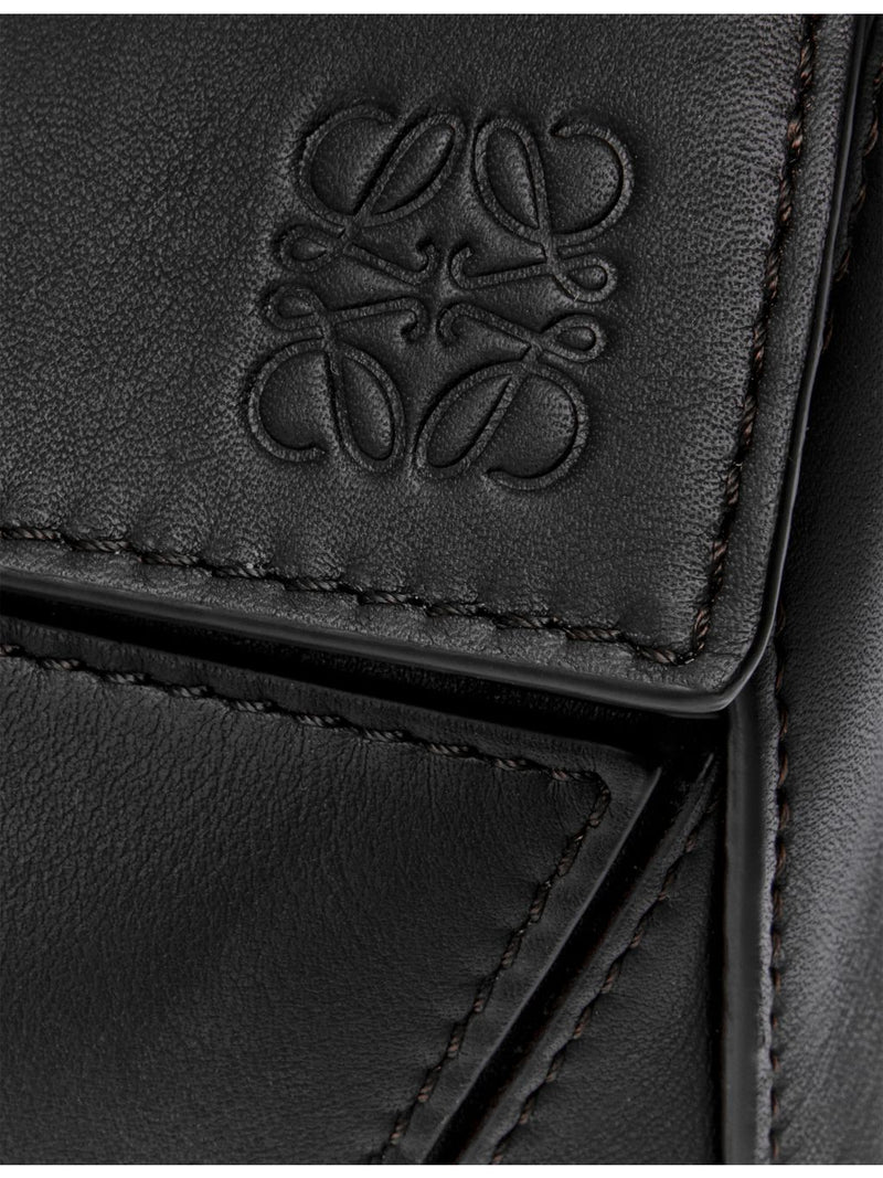 Loewe leather cross-body bag with woven handle (British brand)