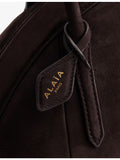 Alaïa small suede top-handle bag with curved shape, UK version