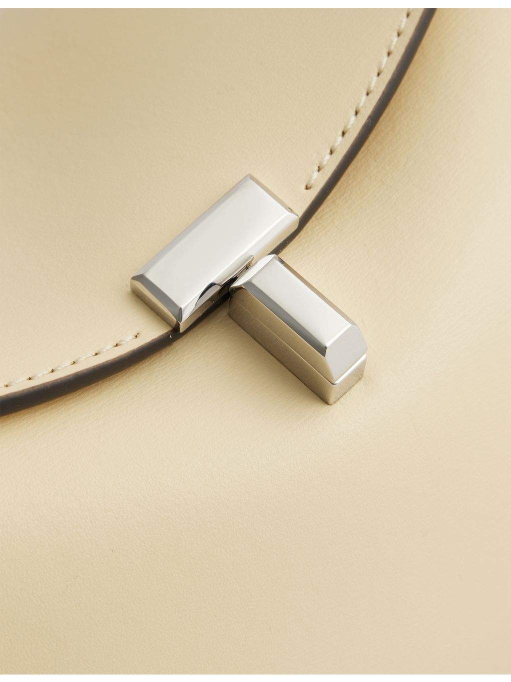 Totême Mini T-Lock leather clutch bag, imported from the UK