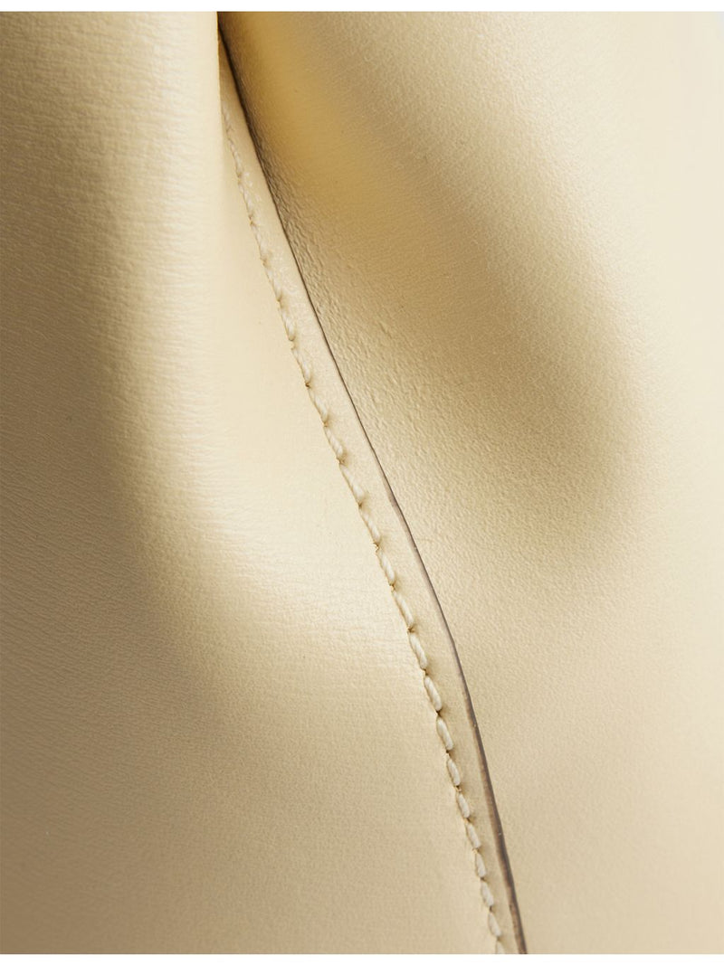 Totême Mini T-Lock leather clutch bag, imported from the UK