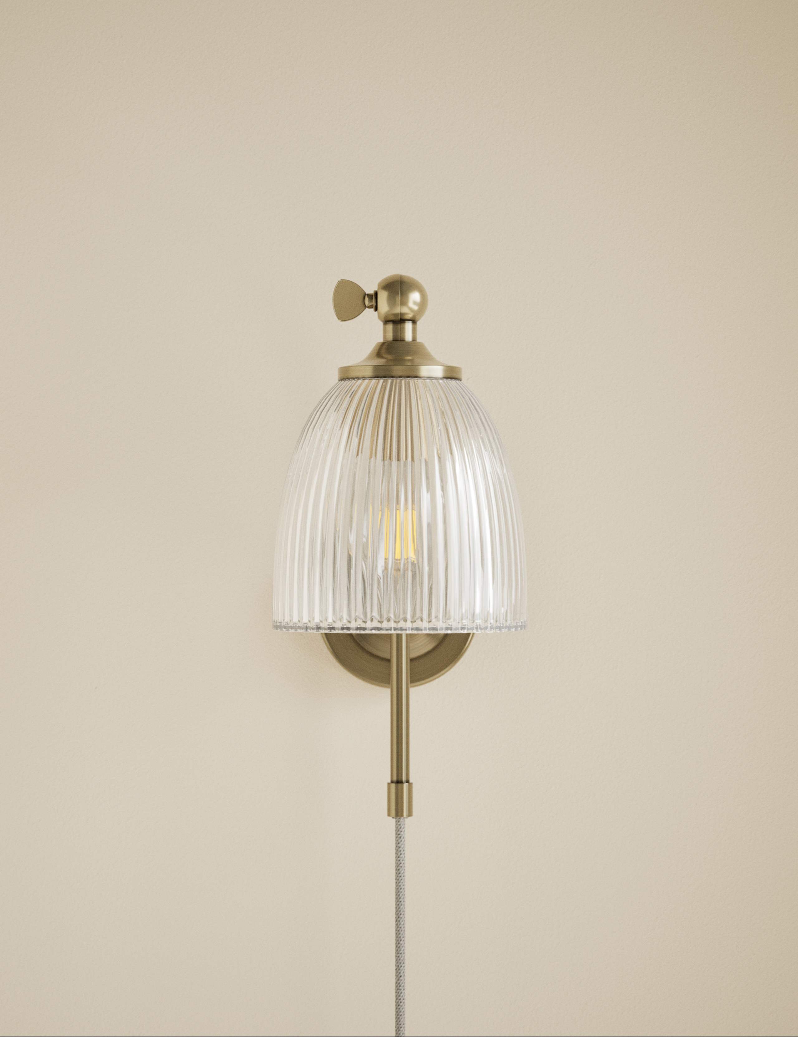 Ribbed plug in wall light with antique brass finish, imported from the UK