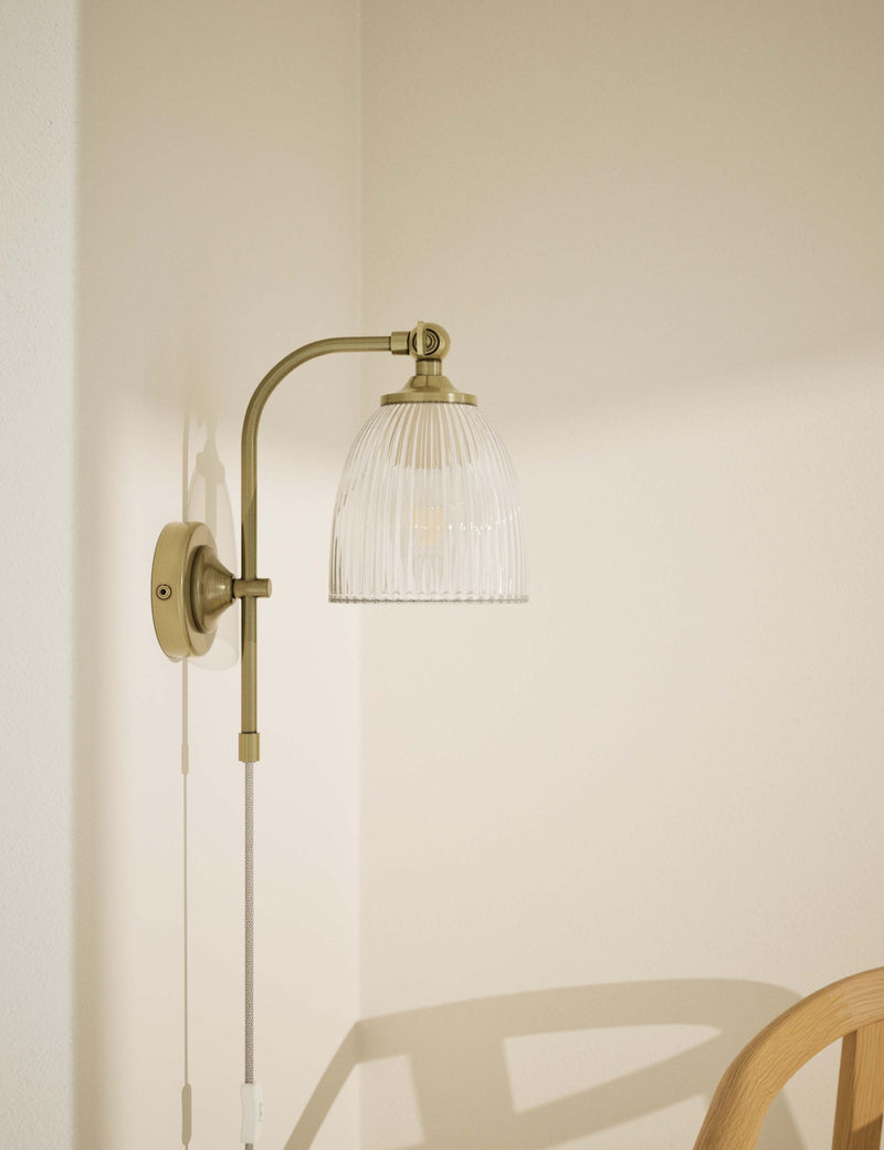 Ribbed plug in wall light with antique brass finish, imported from the UK
