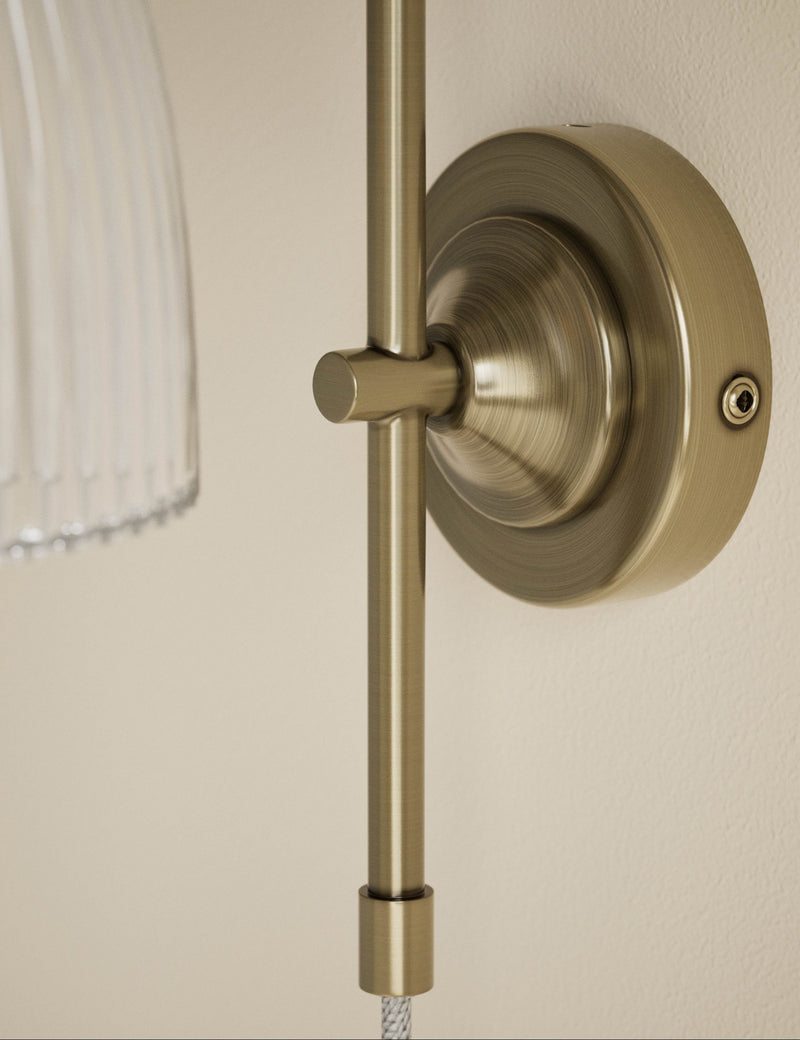 Ribbed plug in wall light with antique brass finish, imported from the UK
