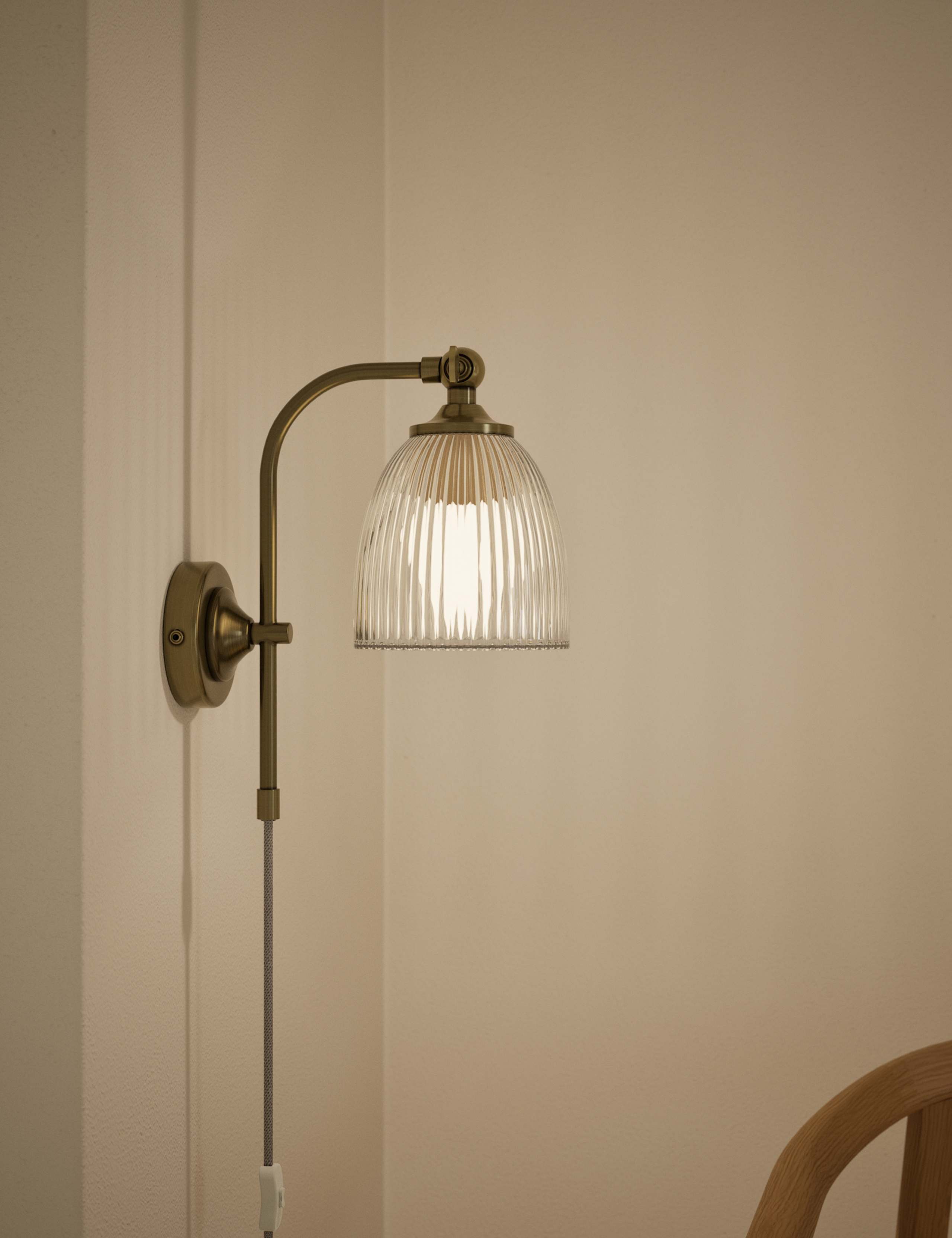Ribbed plug in wall light with antique brass finish, imported from the UK