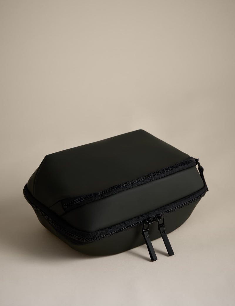 Rubberised travel tech organiser with compartments and secure zip fastenings, UK version