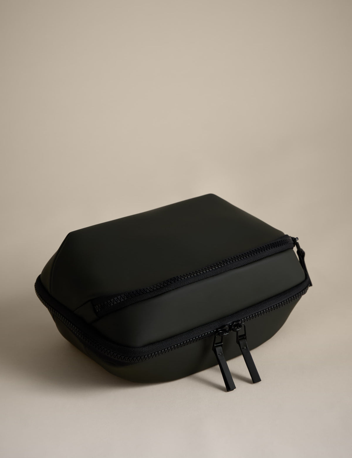 Rubberised travel tech organiser with compartments and secure zip fastenings, UK version