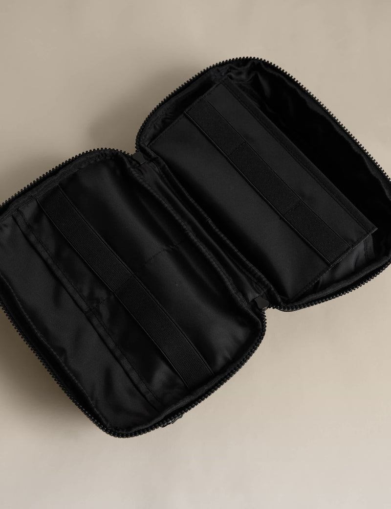 Rubberised travel tech organiser with compartments and secure zip fastenings, UK version