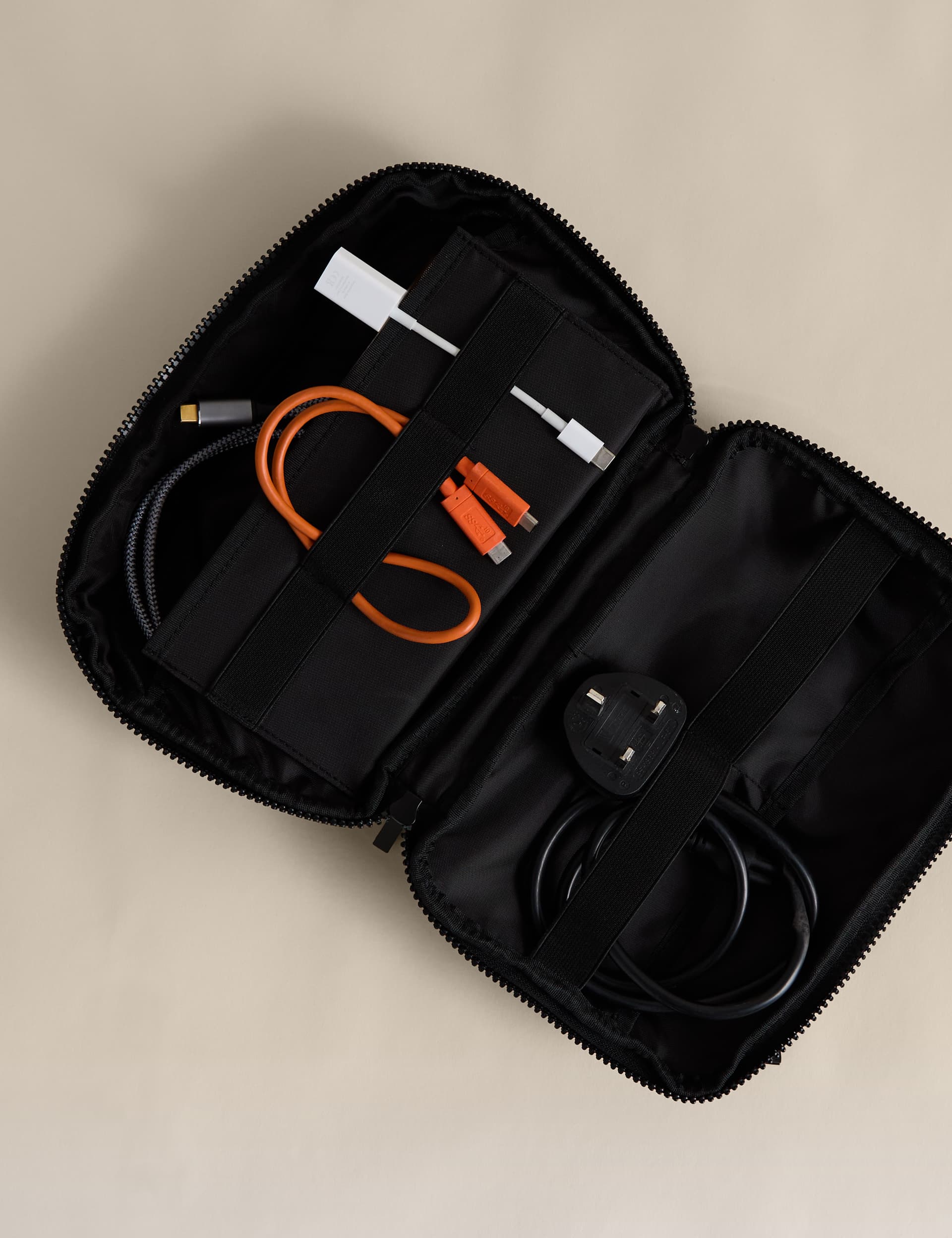 Rubberised travel tech organiser with compartments and secure zip fastenings, UK version