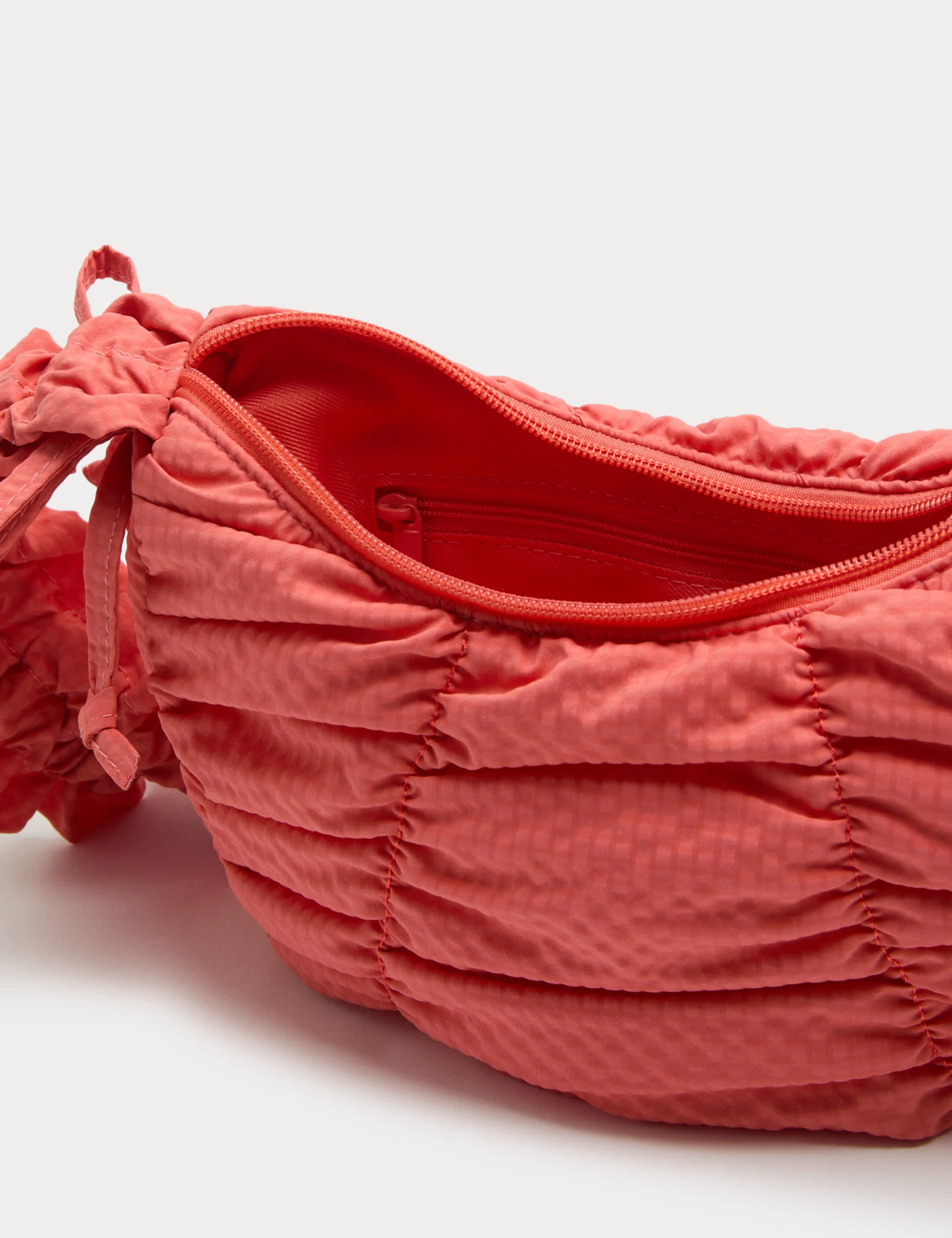 Textured crossbody bag with ruched strap and bows - British product
