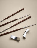 Set of two chopsticks with rests in metal and wood, UK version