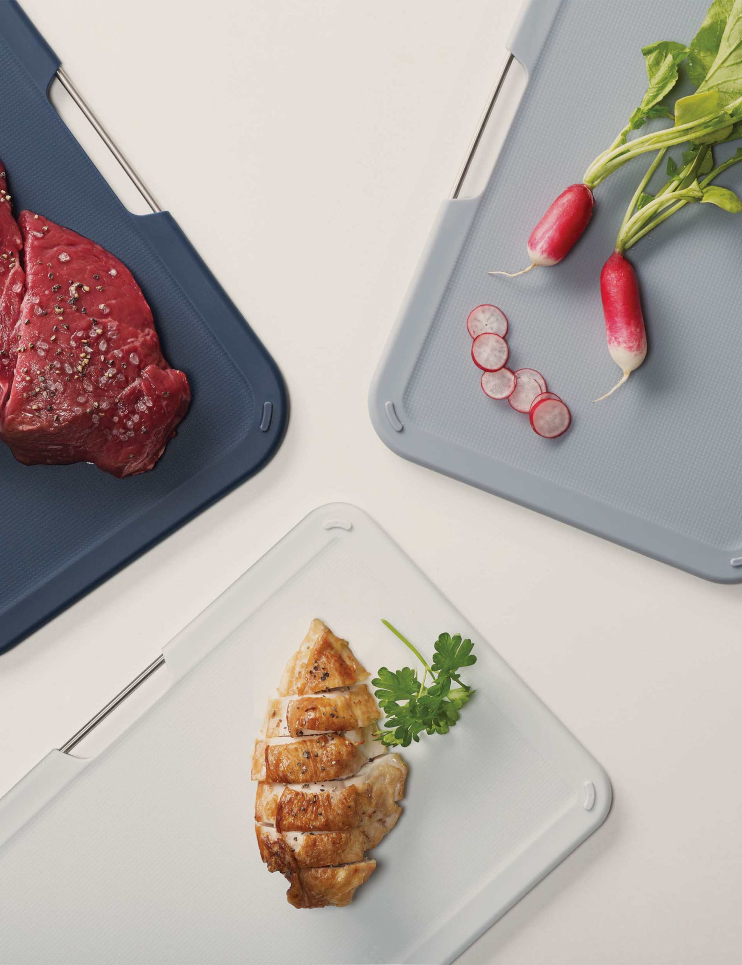 Joseph Joseph set of 3 plastic chopping boards with storage stand (British brand)