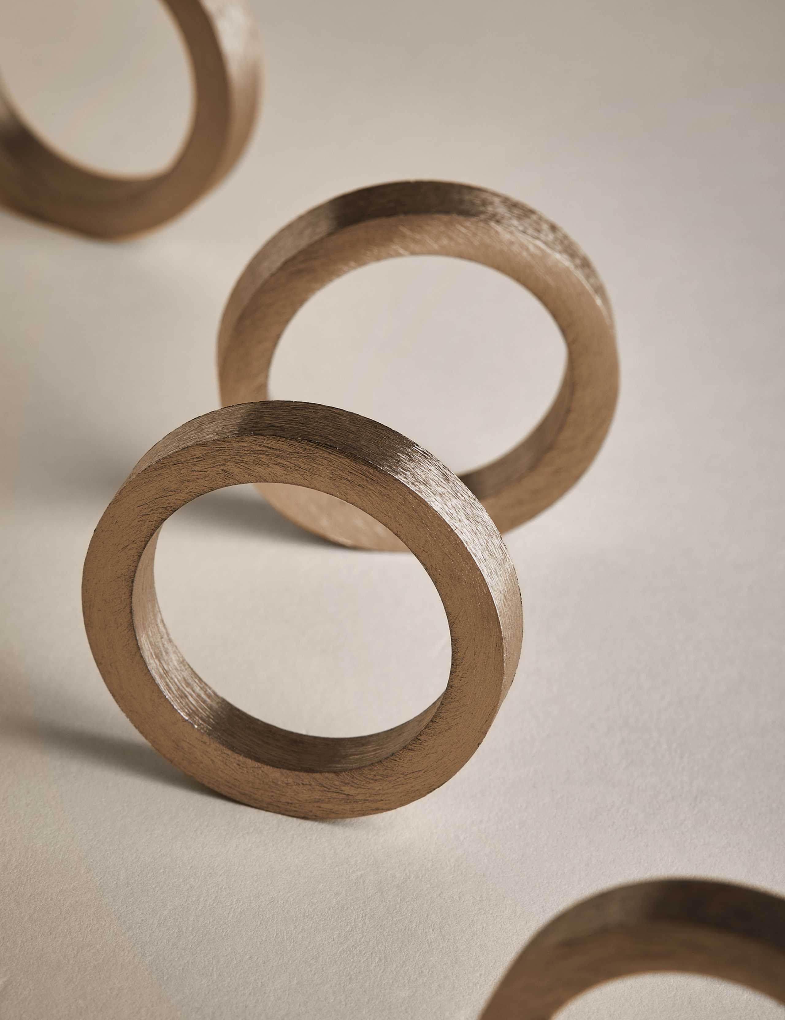 Set of four metallic napkin rings (British brand)
