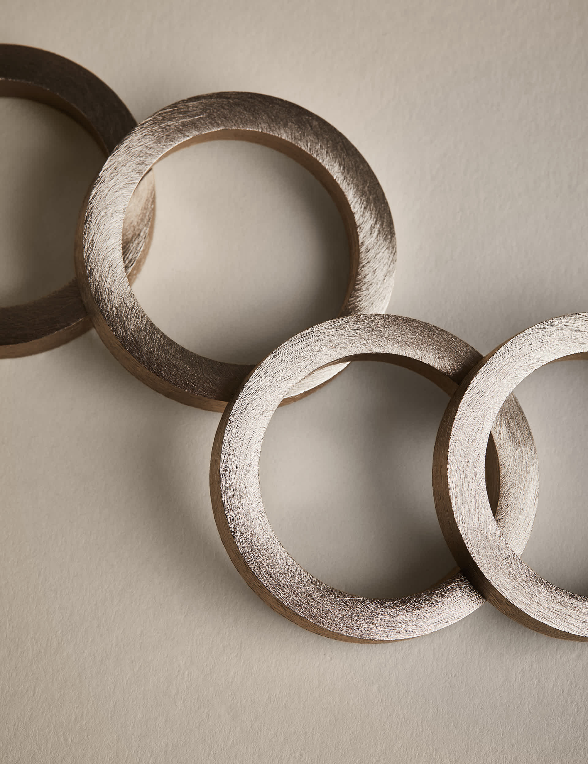 Set of four metallic napkin rings (British brand)