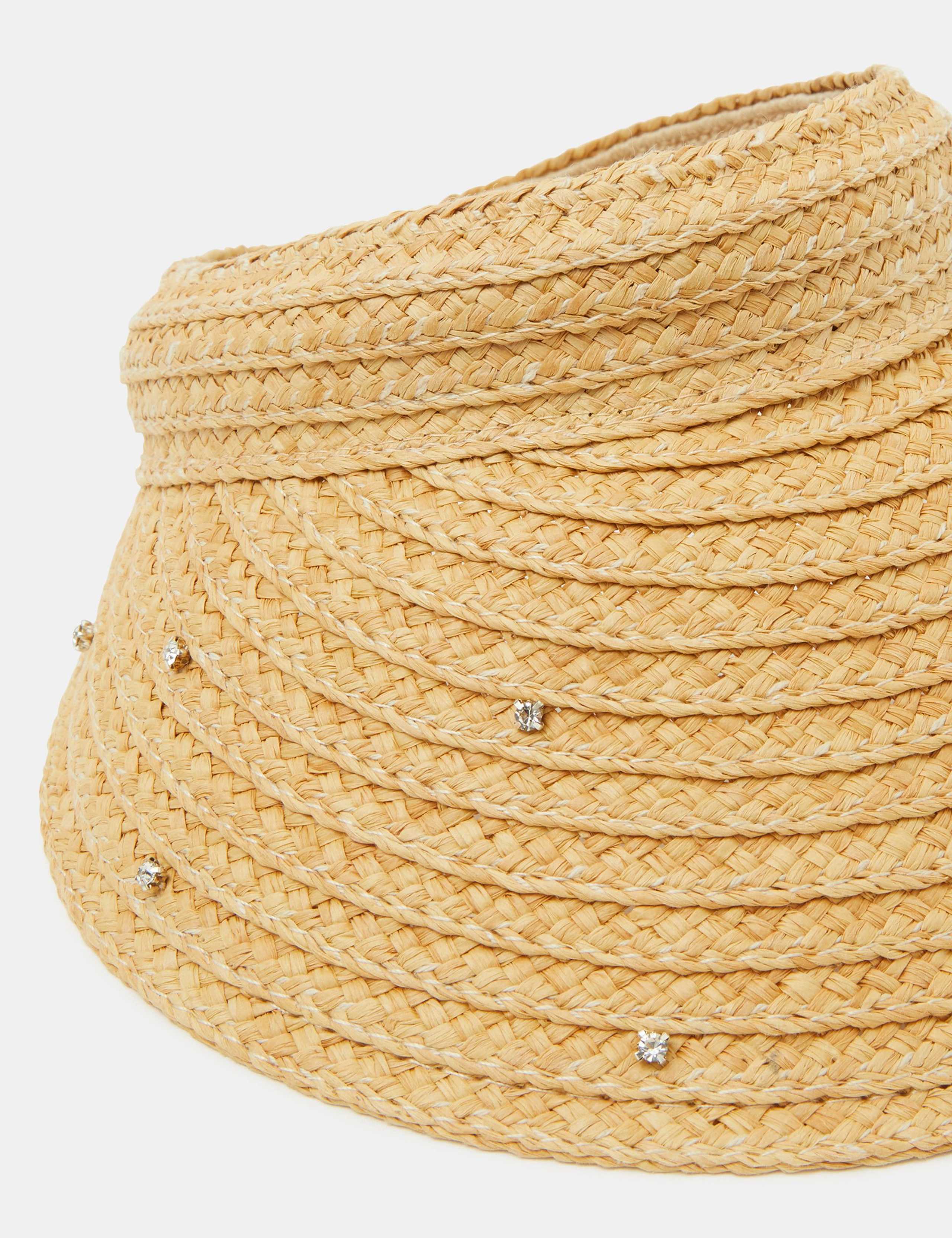 Accessorize straw visor with sparkly embellishments, imported from the UK