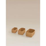 Three natural brown woven baskets, imported from the UK