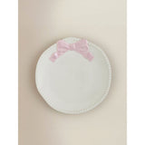 Stoneware side plate with pink and white bow design, imported from the UK