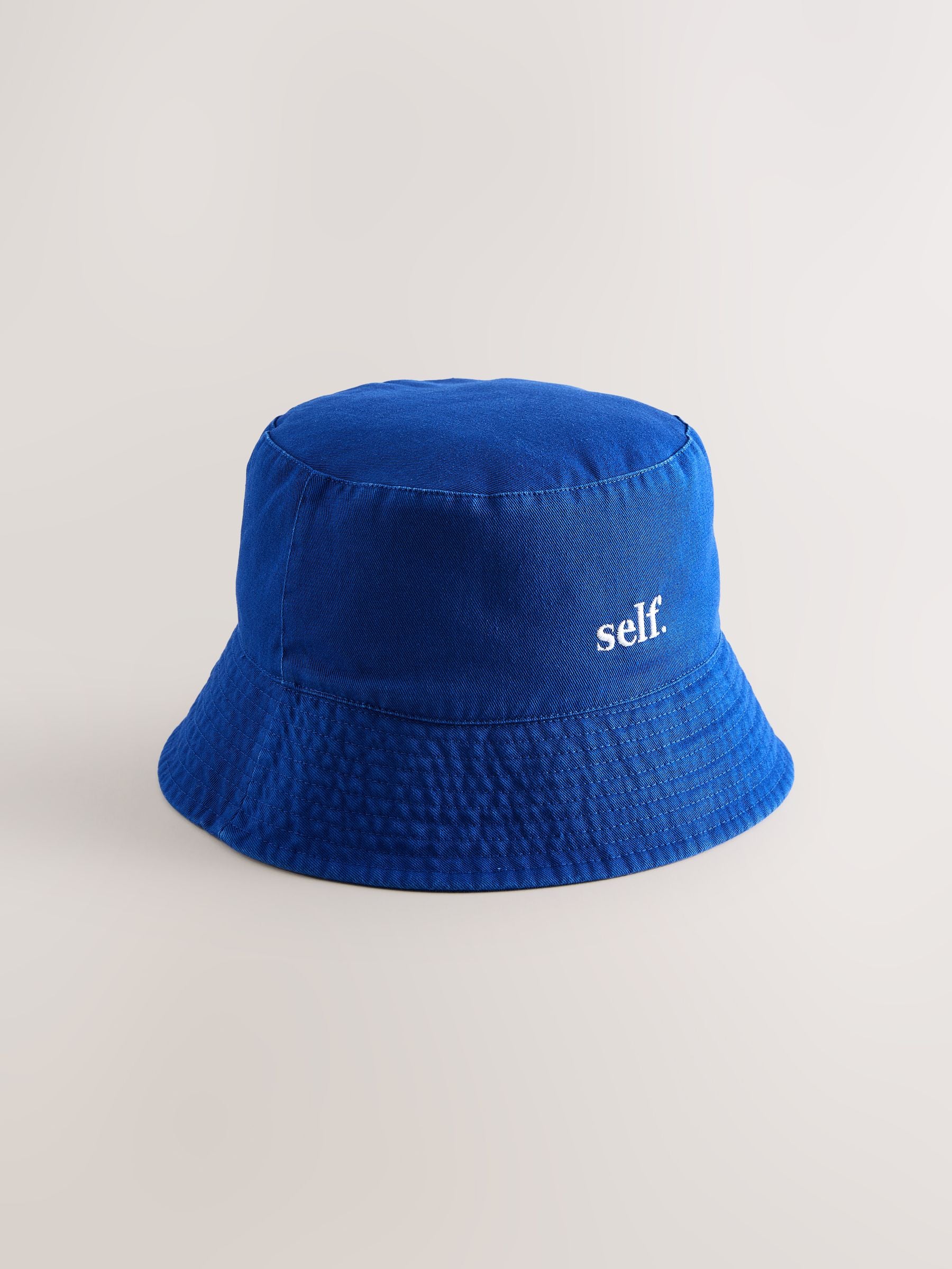 self. cobalt blue bucket hat, imported from the UK