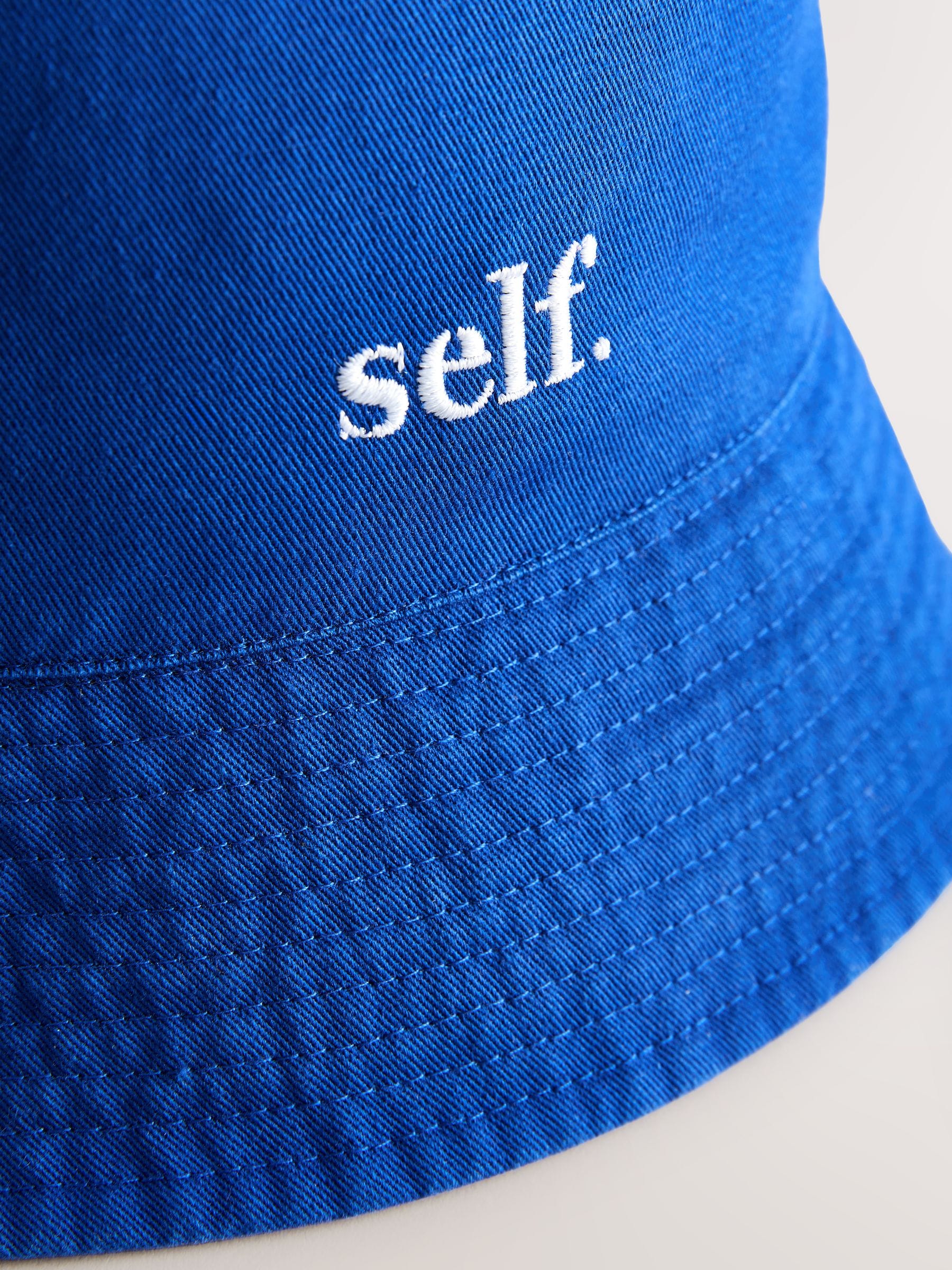 self. cobalt blue bucket hat, imported from the UK