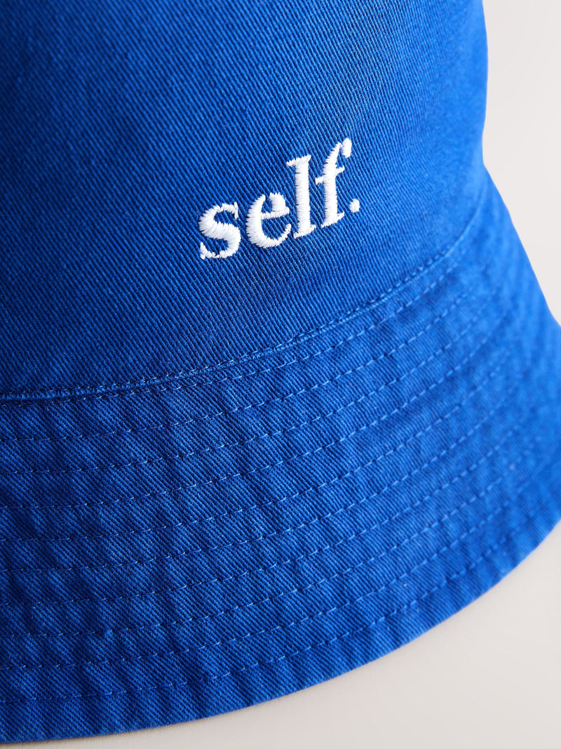 self. cobalt blue bucket hat, imported from the UK