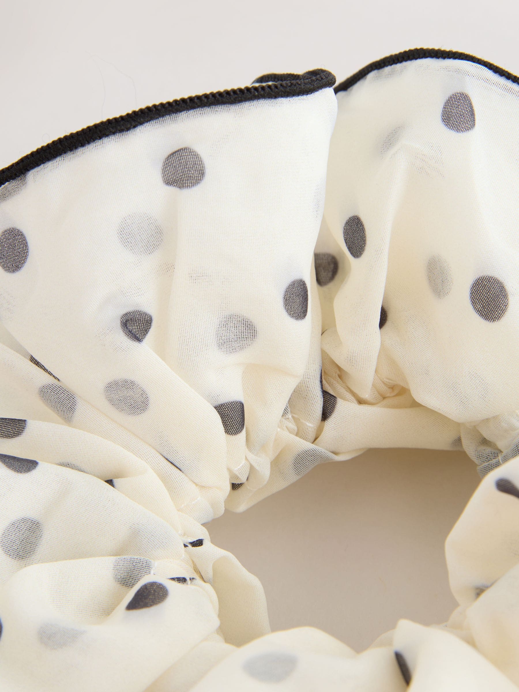 Polka dot scrunchie in white and black (British brand)
