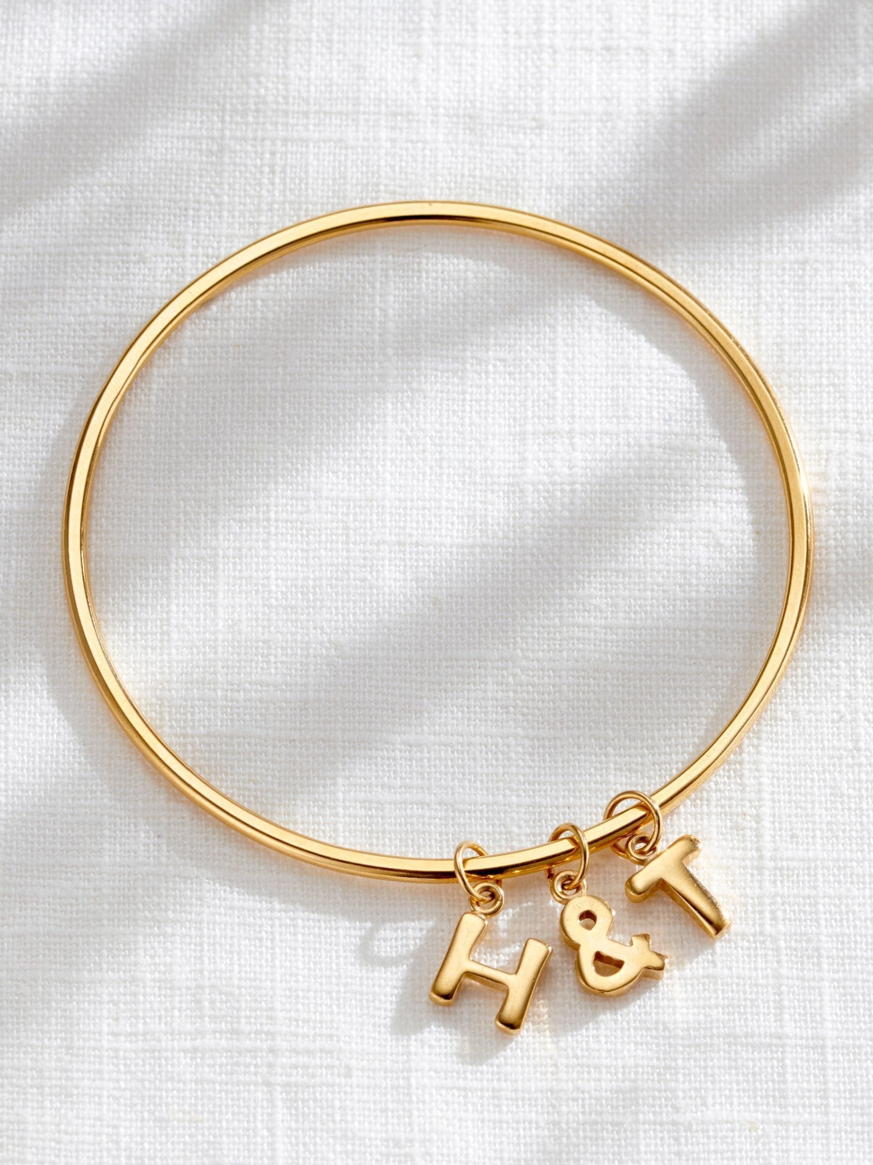 Posh Totty Designs gold tone chunky initial charm bangle, imported from the UK
