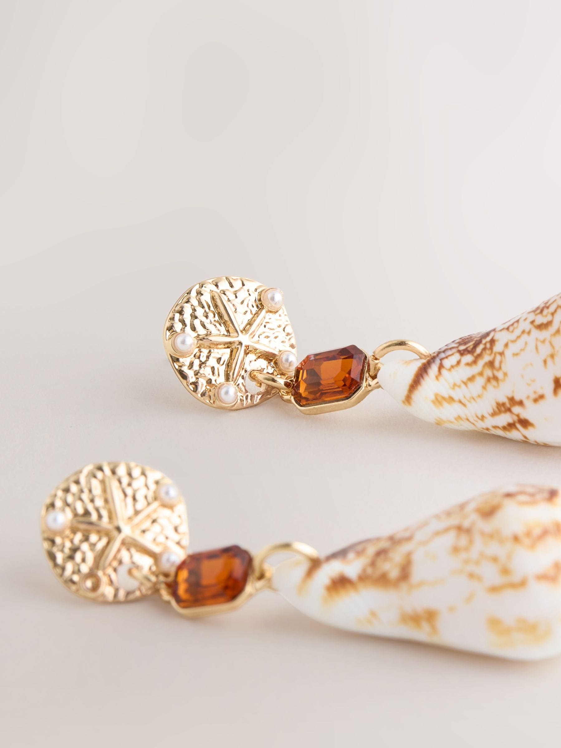 Gold tone shell drop earrings with gemstone accents (British brand)