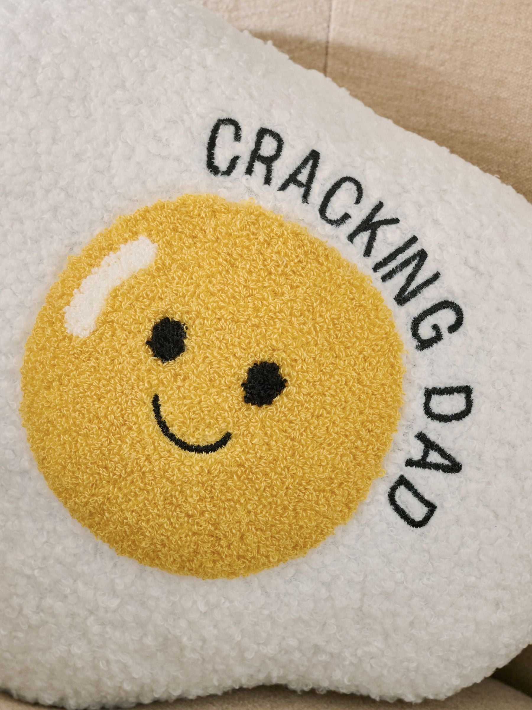 Father's Day cracking egg cushion in ochre yellow, imported from the UK