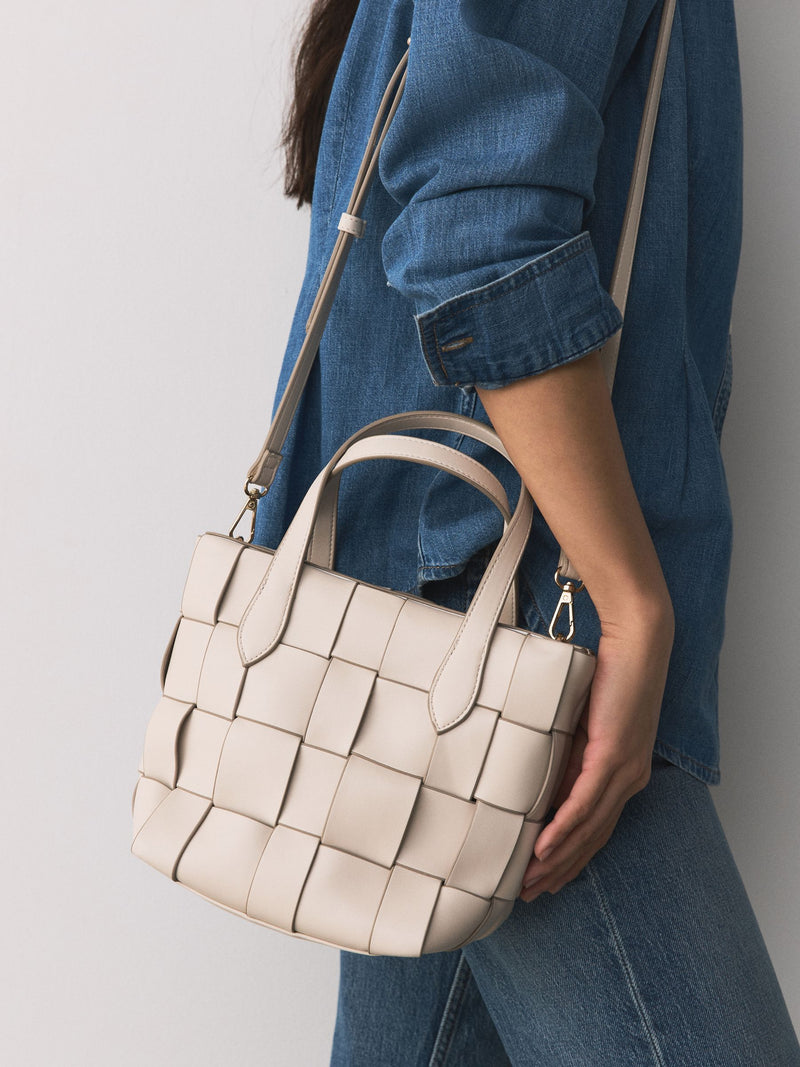Bone Weave hand held bag with woven texture and recycled lining, imported from the UK