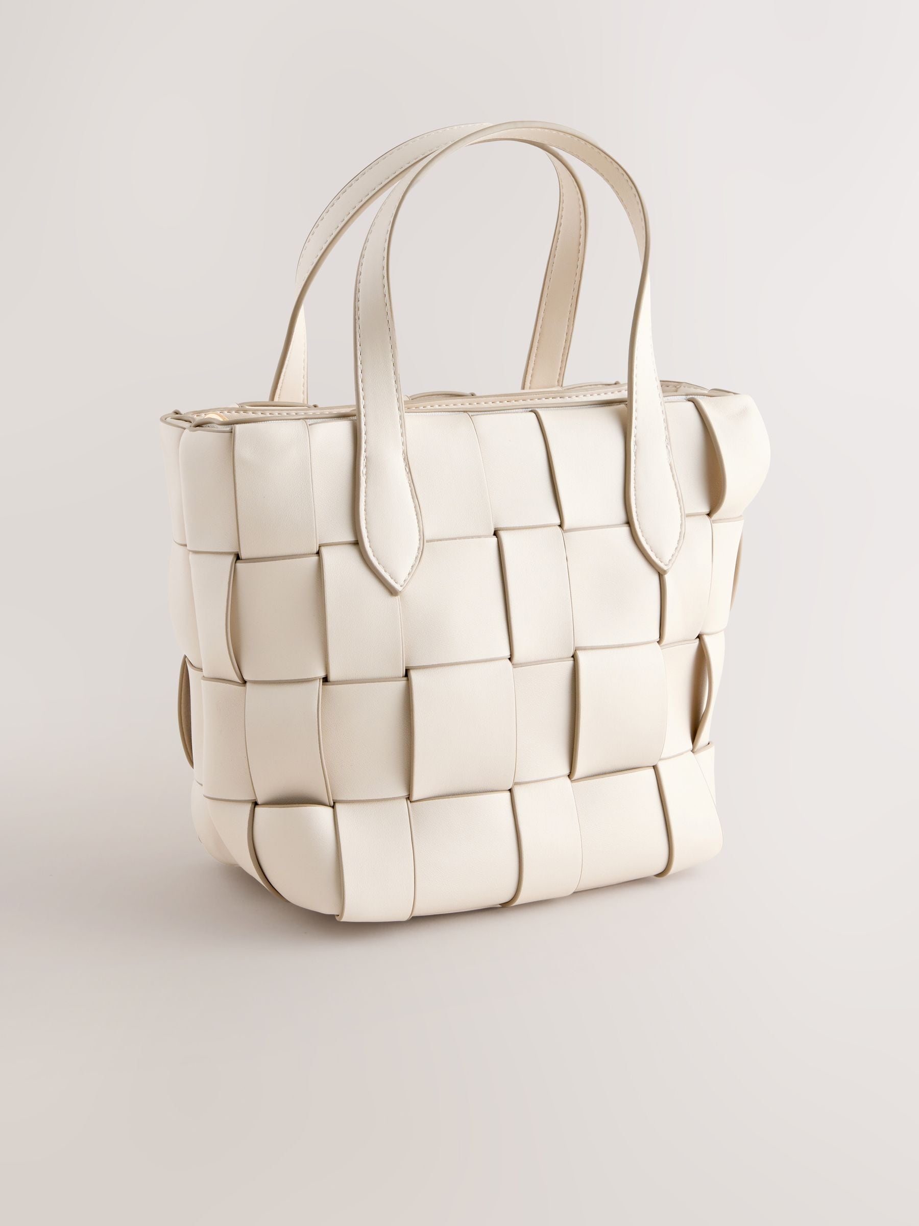 Bone Weave hand held bag with woven texture and recycled lining, imported from the UK