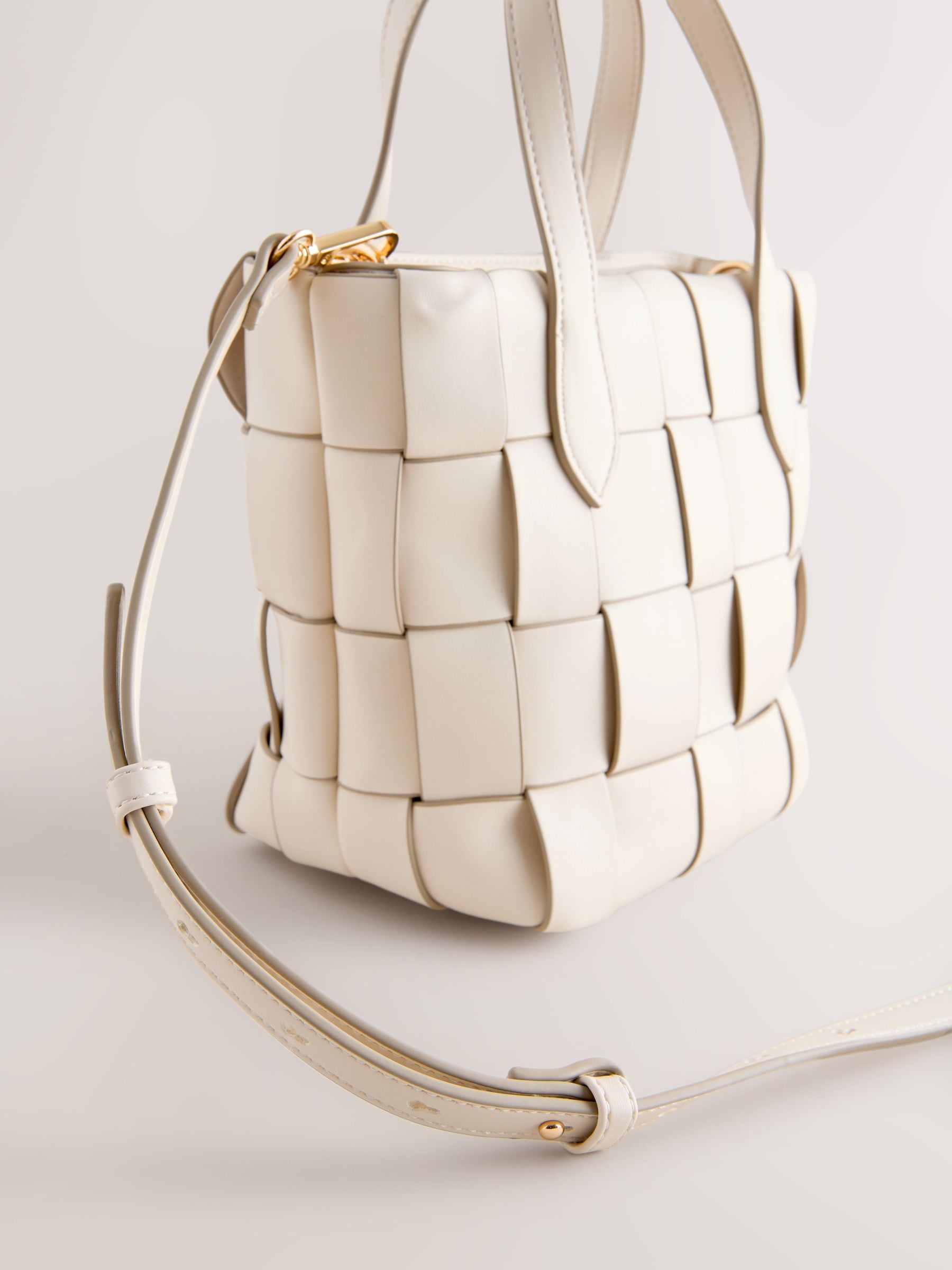 Bone Weave hand held bag with woven texture and recycled lining, imported from the UK