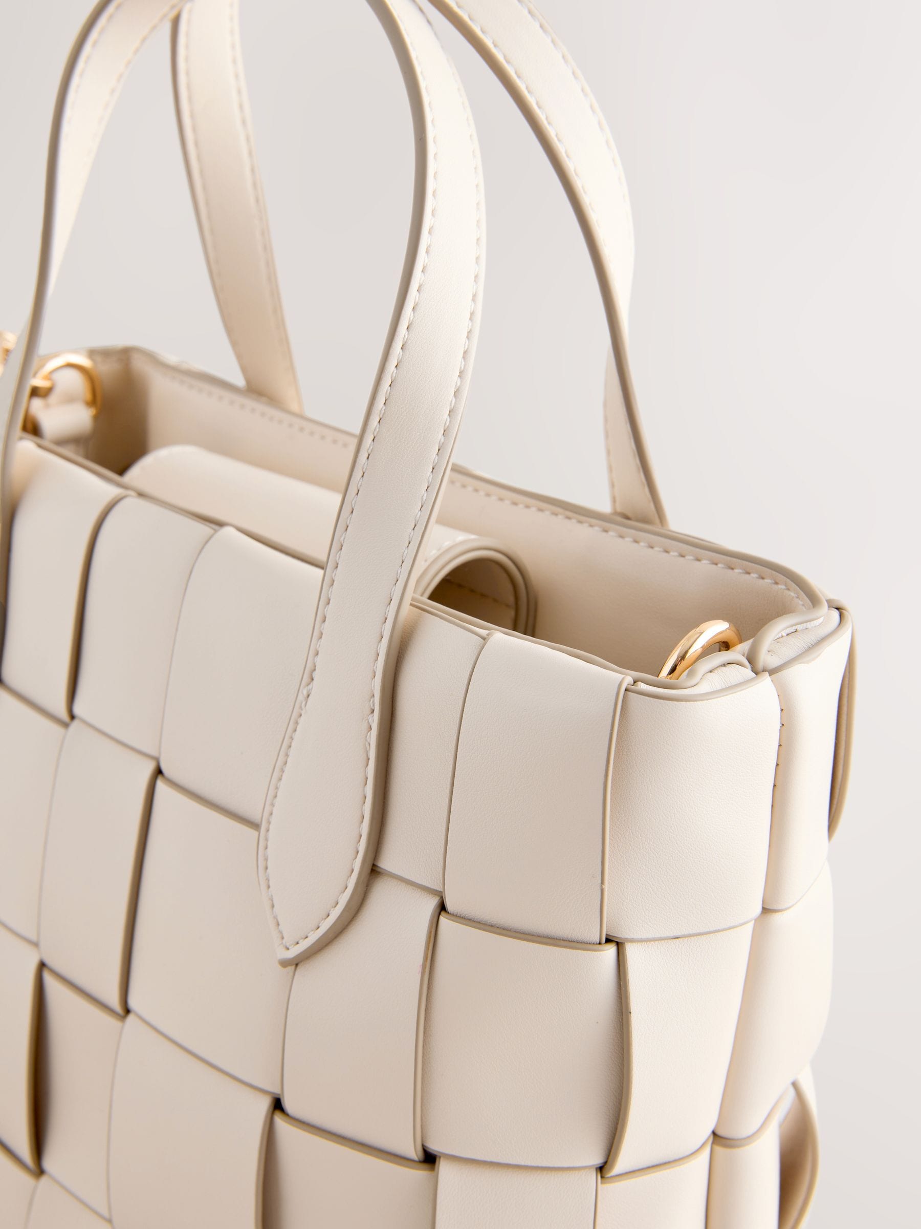 Bone Weave hand held bag with woven texture and recycled lining, imported from the UK
