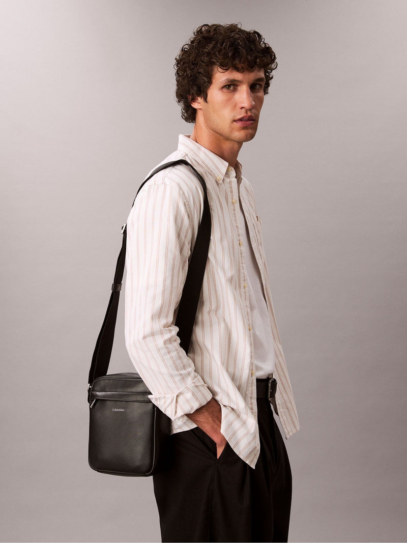 Calvin Klein black raised reporter bag (British brand)