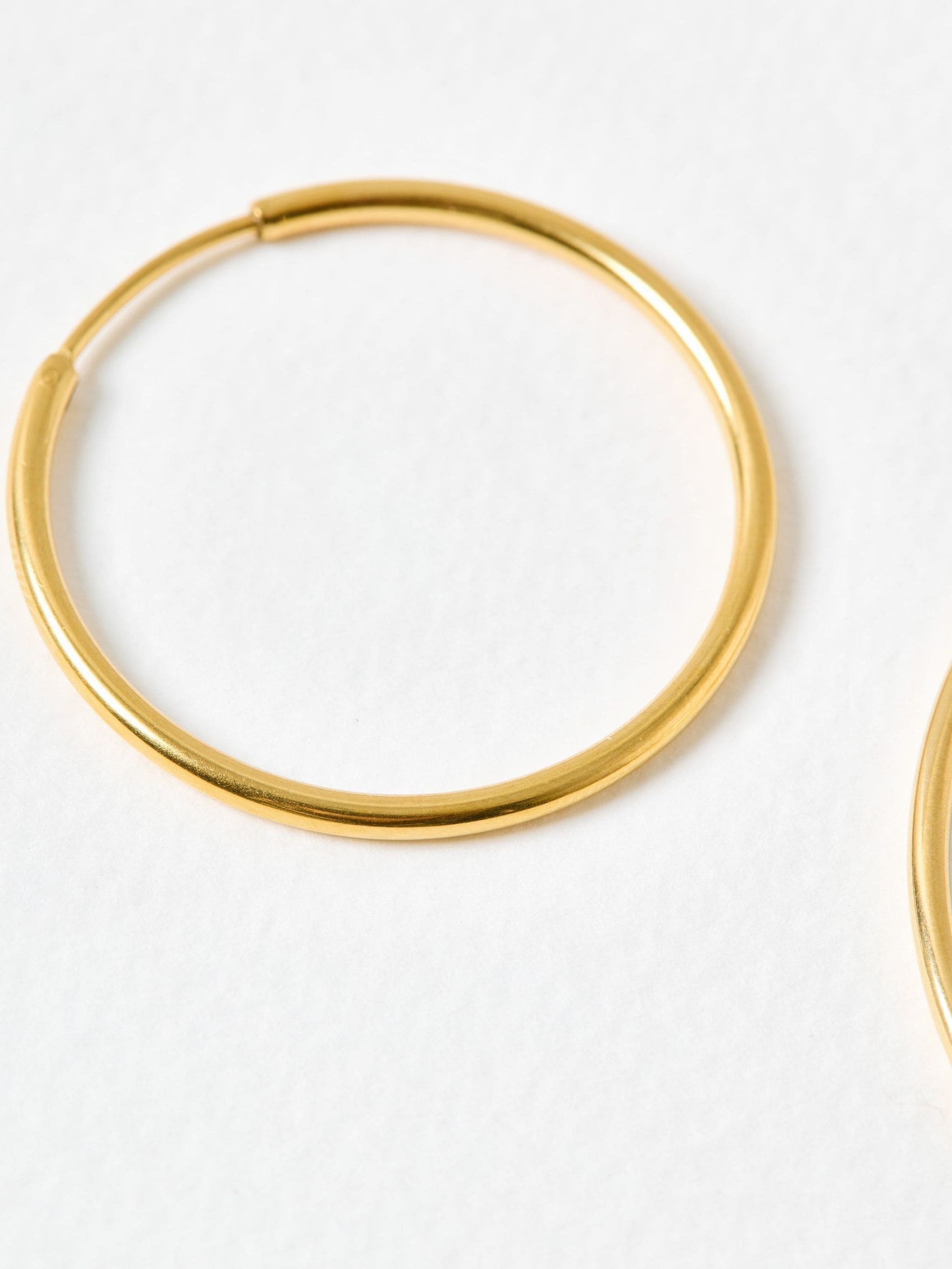 Oliver Bonas gold tone small hoop earrings, UK version