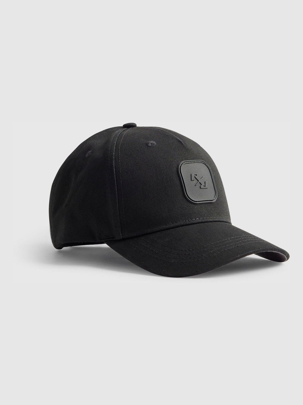 River Island black baseball cap with rubber logo badge, imported from the UK
